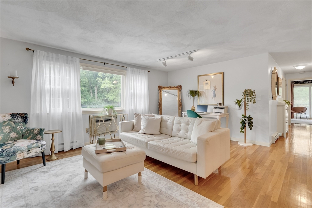 71 Stone Street, Unit 5 Walpole, MA 02081 - Photo 8 of 18 a living room with furniture and a large window