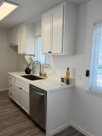 a kitchen with sink a cabinets and window