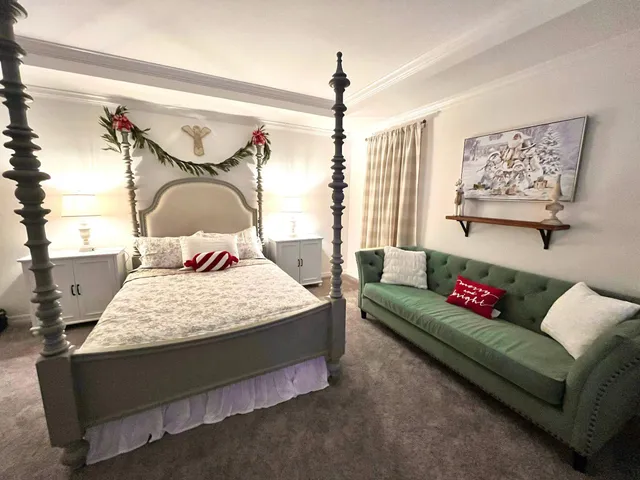 a bedroom with a bed couch and window