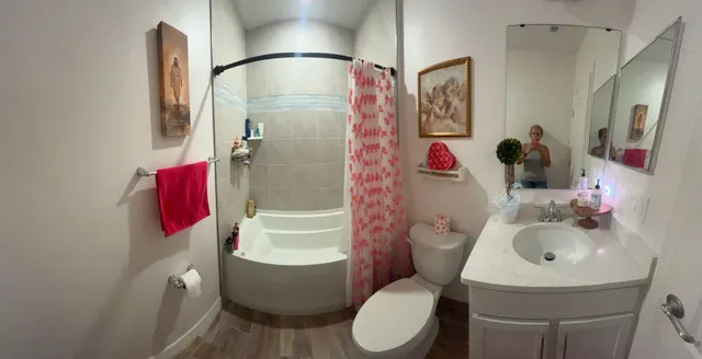 a bathroom with a sink toilet and shower