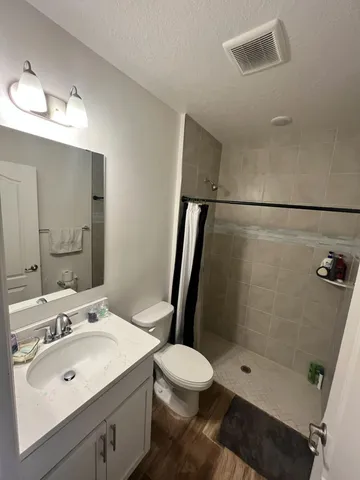 a bathroom with a sink toilet and shower