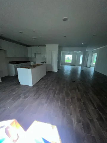 a view of kitchen and hall with wooden floor