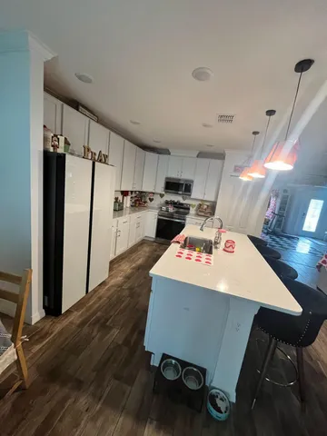 a room with wooden floor and furniture