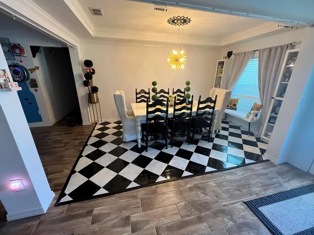 a black and white checkered floor with a rug