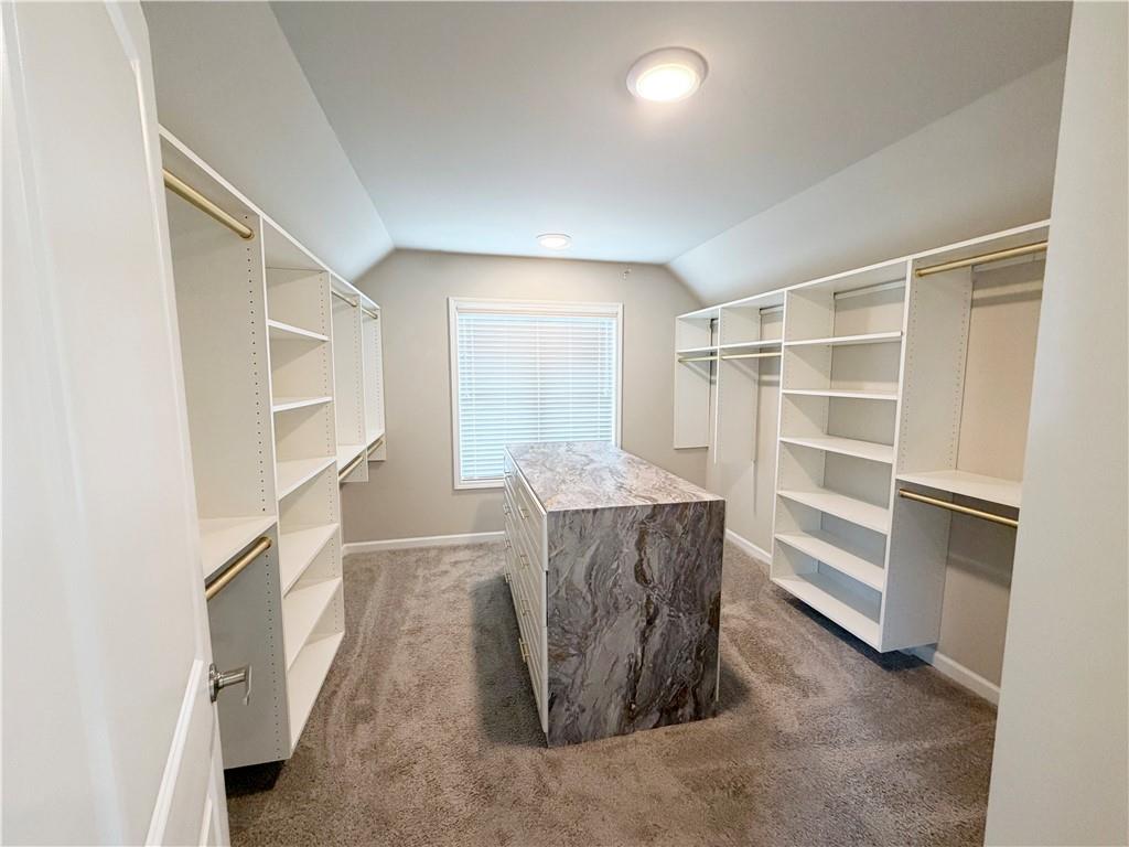 5296 Cheval Rue Court Suwanee, GA 30024 - Photo 25 of 51 a view of closet area with empty racks