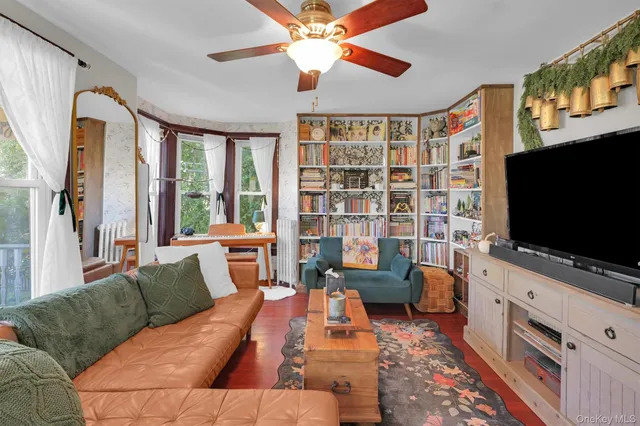 a living room with furniture and a flat screen tv