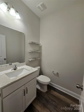 a bathroom with a sink a toilet and mirror