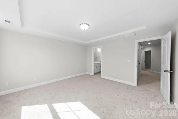 a view of a big room with windows and chandelier fan