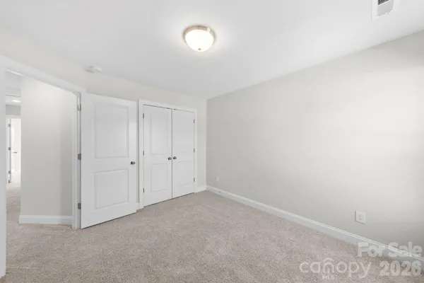 a bedroom with bed and a chandelier