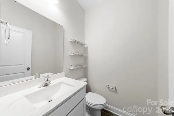 a view of a white house and a road