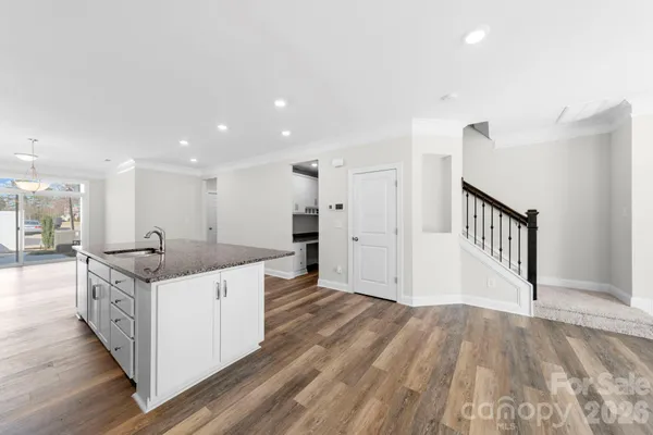 a kitchen with a sink and a stove top oven