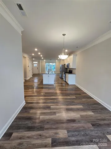 a view of a room with kitchen island and wooden floor