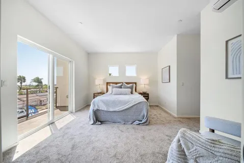 a spacious bedroom with a bed and a couch