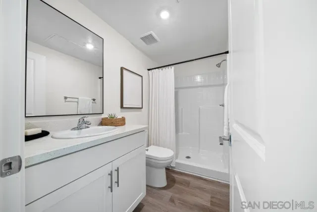 a bathroom with a glass shower door