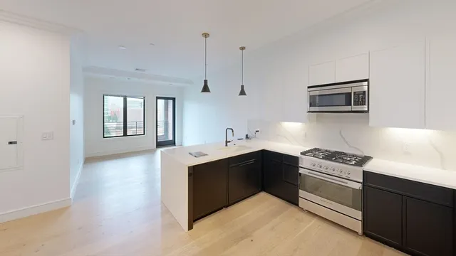 a kitchen with granite countertop a sink and cabinets