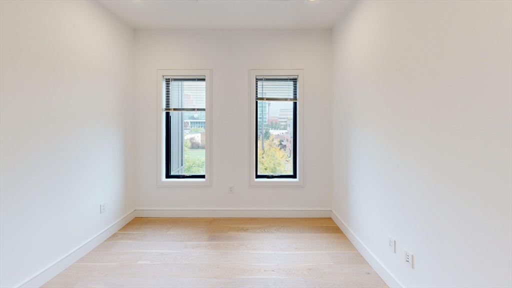 50 Leo M Birmingham Parkway, Unit 506 Boston, MA 02135 - Photo 5 of 10 an empty room with windows