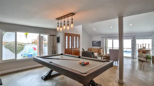 a kitchen that has a table chairs in it and wooden floors