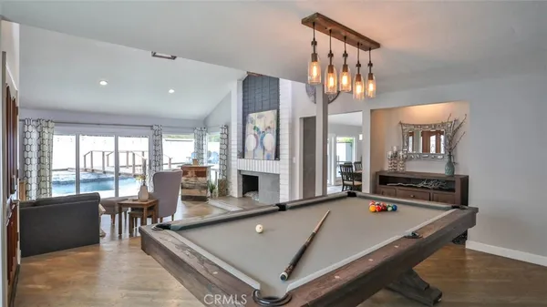 a bedroom with a bed flat screen tv and a large window