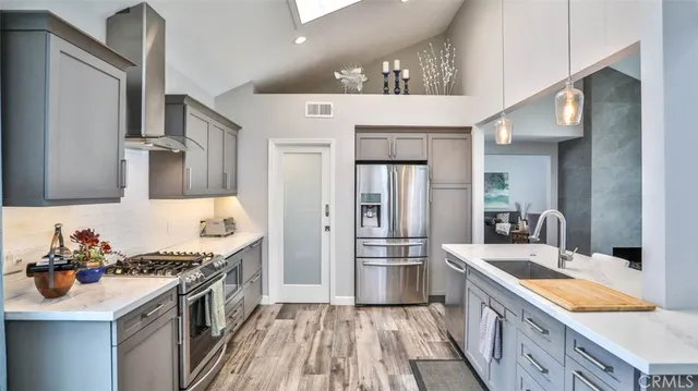 a kitchen that has a table chairs in it and wooden floors