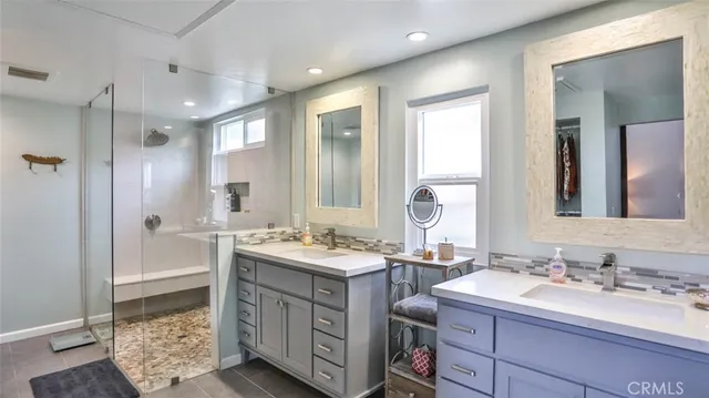 a bedroom with a bed and a mirror on the dresser