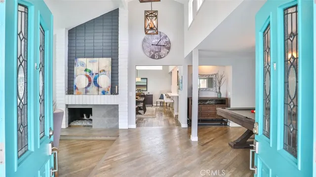 a living room with furniture a fireplace and a floor to ceiling window
