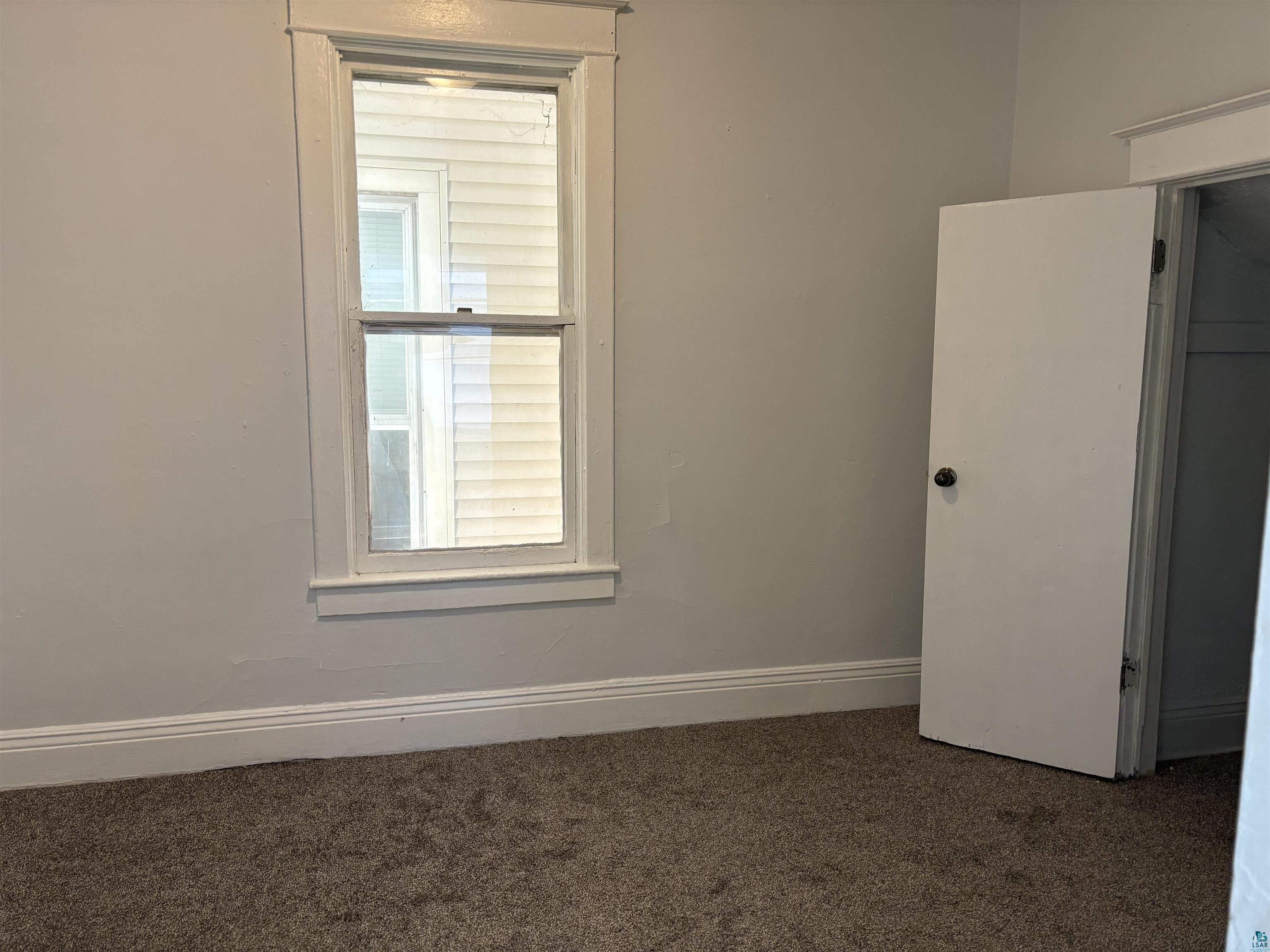 2967 Exeter Street Duluth, MN 55806 - Photo 12 of 31 Unfurnished room featuring dark carpet and a wealth of natural light