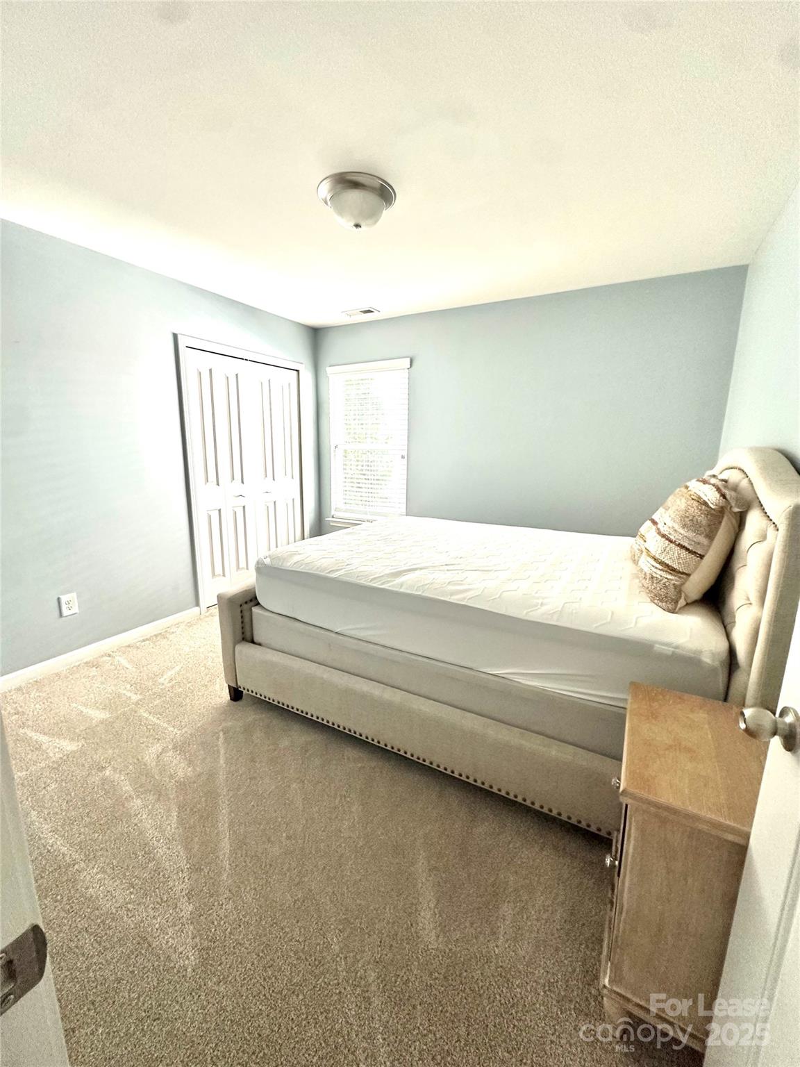 16732 Prairie Falcon Lane Charlotte, NC 28278 - Photo 11 of 18 a bedroom with a bed and a window