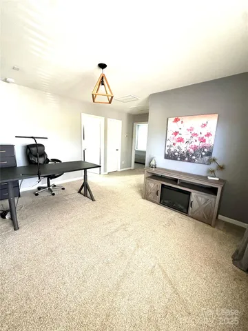 a living room with furniture gym equipment and a window