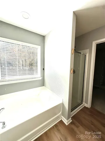 a spacious bathroom with a bathtub and a shower