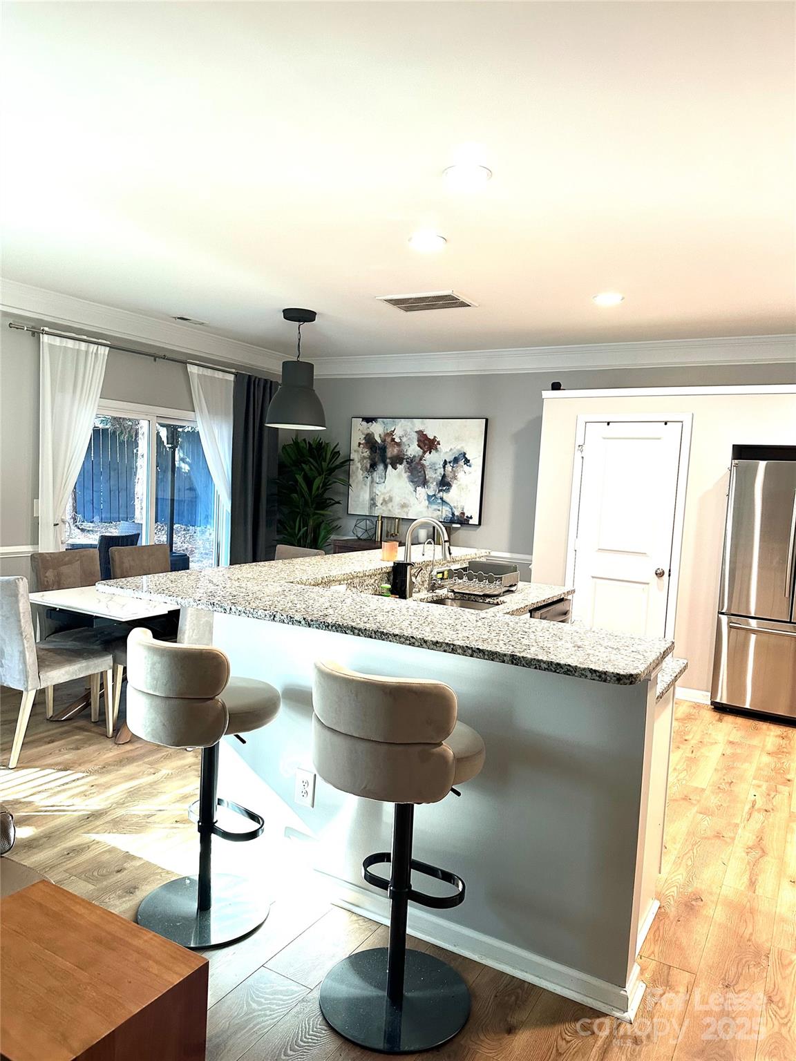 16732 Prairie Falcon Lane Charlotte, NC 28278 - Photo 6 of 18 a kitchen with granite countertop a counter space a chandelier and living room