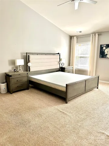 a bedroom with a bed and window