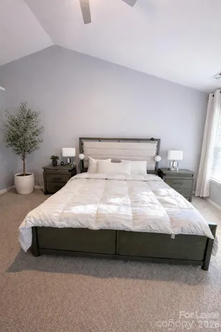 a bedroom with bed and a potted plant