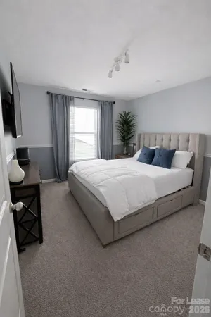 a bedroom with a bed and a flat screen tv