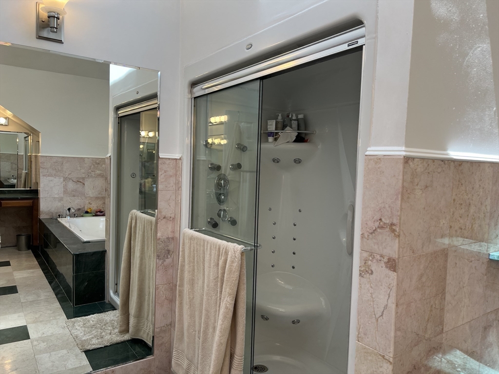 11 Garrison Road, Unit 1 Arlington, MA 02474 - Photo 25 of 42 a bathroom with a tub and shower