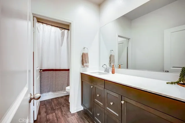 a spacious bathroom with a double vanity sink and mirror