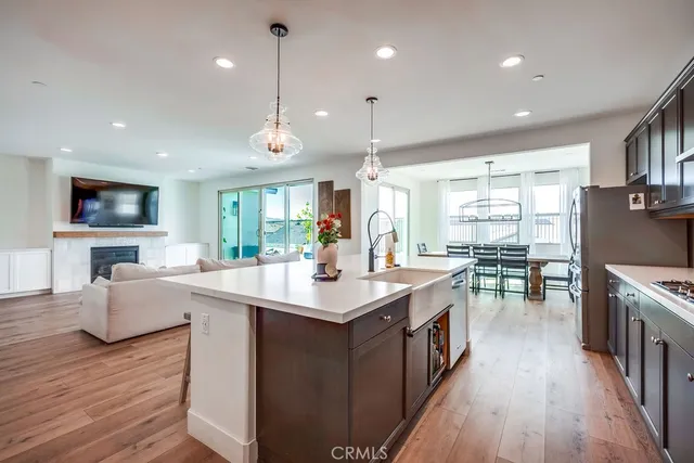 a kitchen with counter top space sink stove and wooden floor