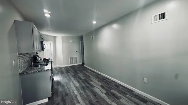 a view of a room with wooden floor