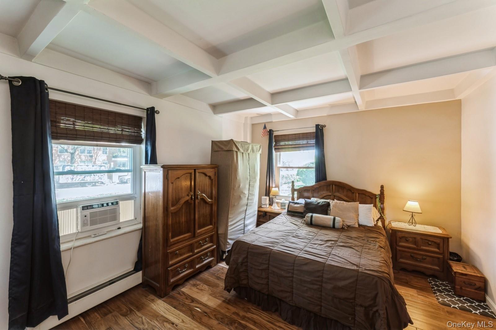 149-32 Union Turnpike, Unit 24A Queens, NY 11367 - Photo 2 of 18 a bedroom with a bed and wooden floor