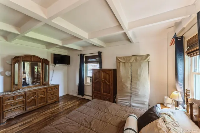 a bedroom with furniture and a mirror