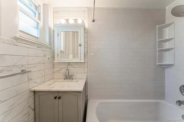a bathroom with a sink a vanity and window