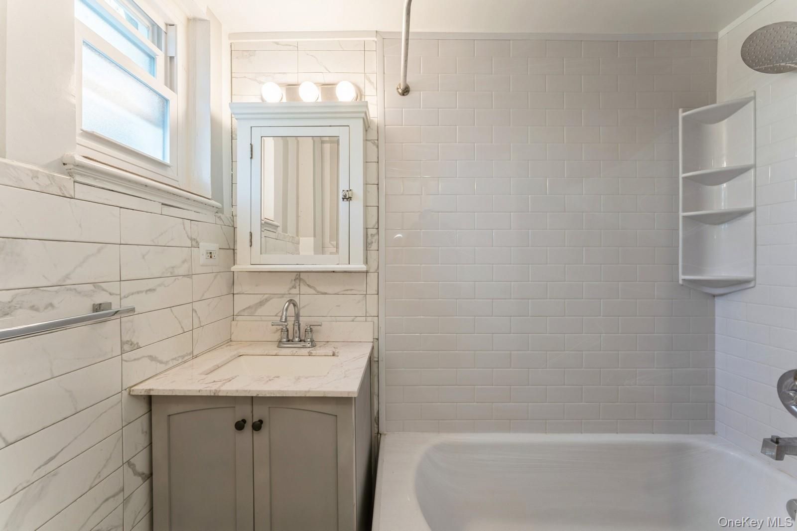149-32 Union Turnpike, Unit 24A Queens, NY 11367 - Photo 4 of 18 a bathroom with a sink a vanity and window