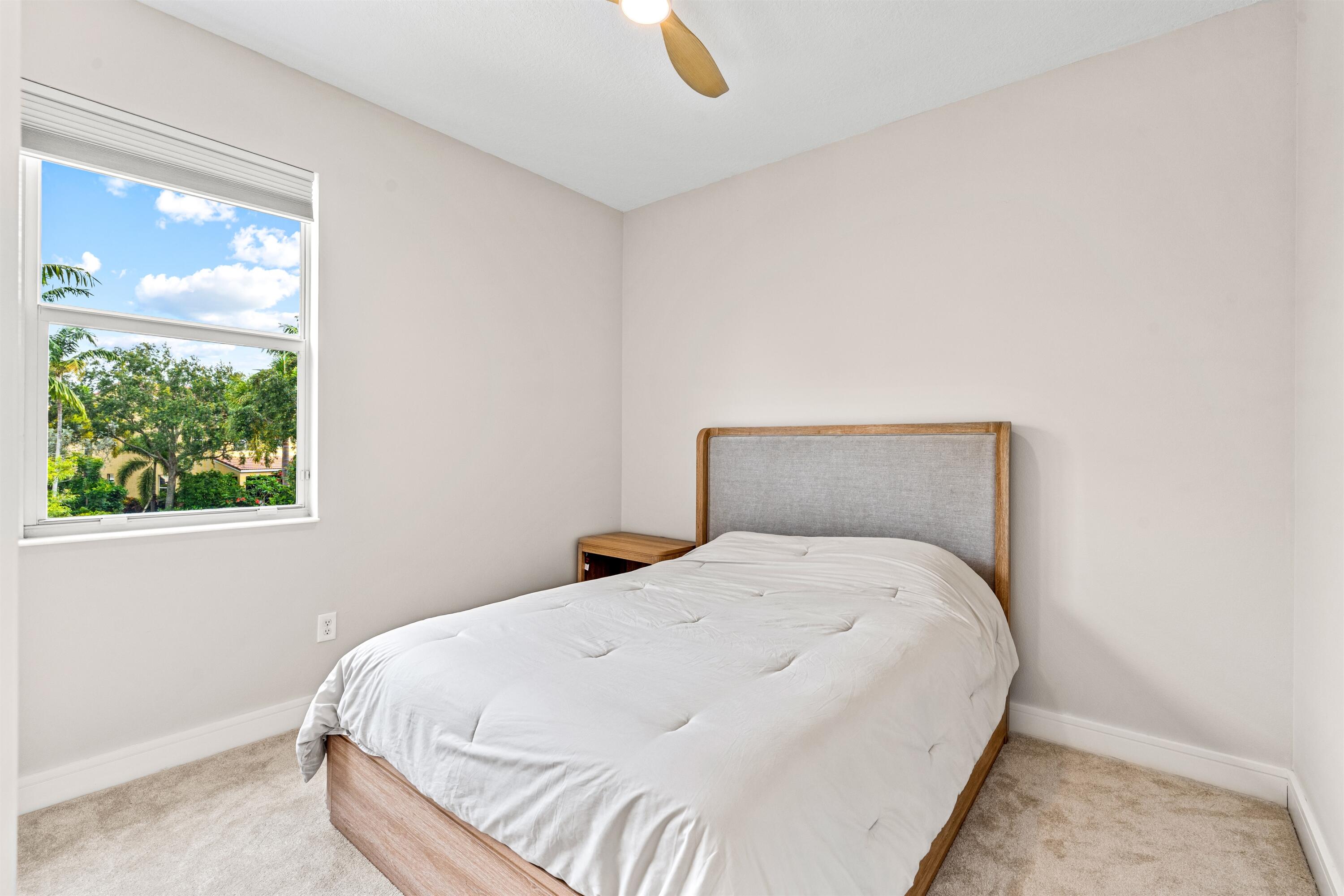1570 Northwest 48th Place Boca Raton, FL 33431 - Photo 22 of 30 a large bed sitting in a bedroom next to a window