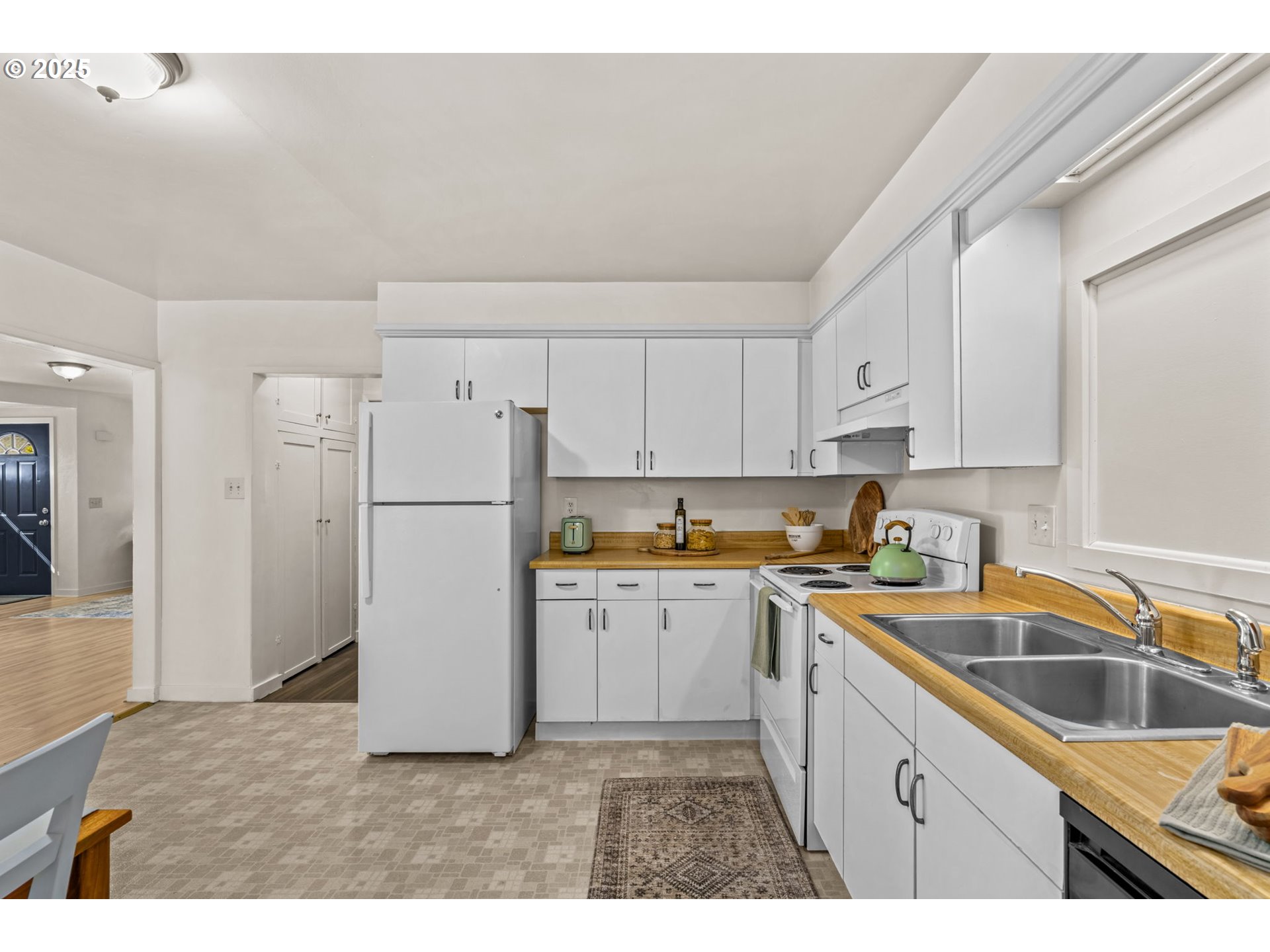 1149 Northwest 10th Street Corvallis, OR 97330 - Photo 16 of 29 a kitchen with a refrigerator a sink and cabinets