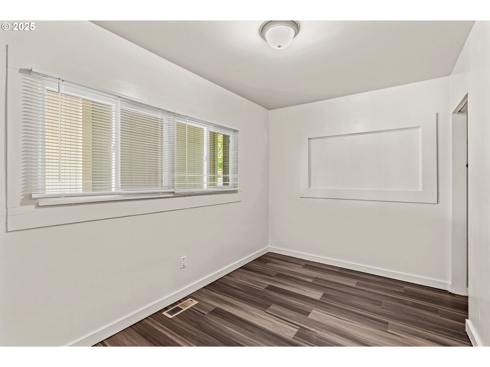 1149 Northwest 10th Street Corvallis, OR 97330 - Photo 18 of 29 a view of an empty room with wooden floor and a window