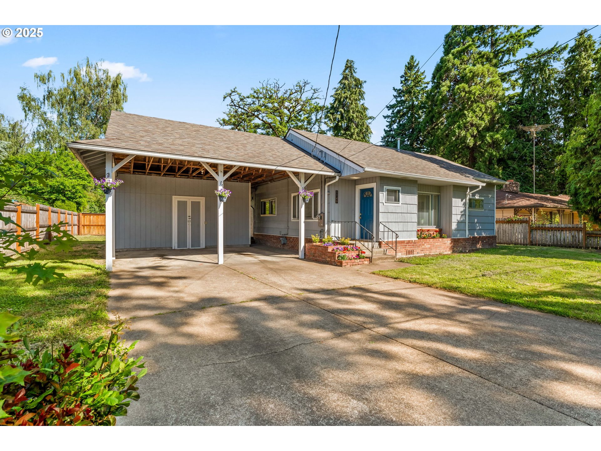 1149 Northwest 10th Street Corvallis, OR 97330 - Photo 2 of 29 a view of a white house with a big yard and large trees