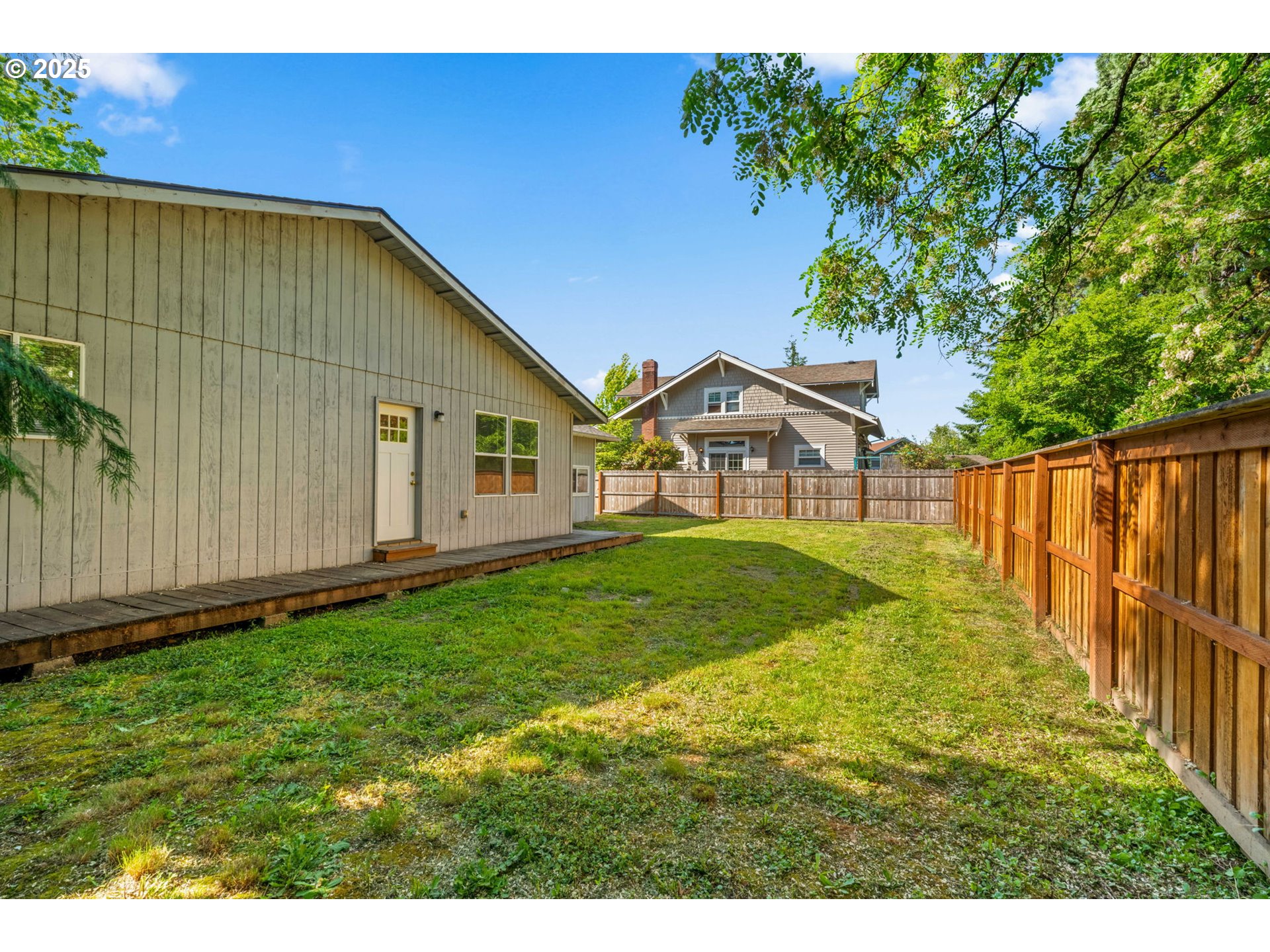 1149 Northwest 10th Street Corvallis, OR 97330 - Photo 25 of 29 a view of a backyard with table and chairs and wooden fence
