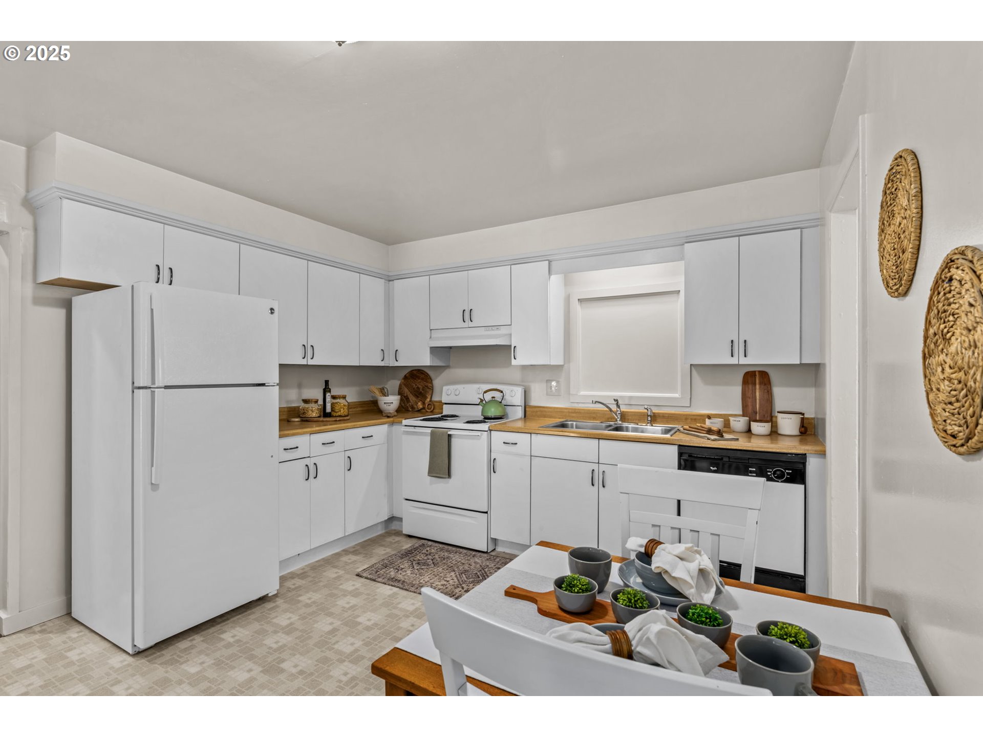 1149 Northwest 10th Street Corvallis, OR 97330 - Photo 10 of 29 a kitchen with a refrigerator and white cabinets