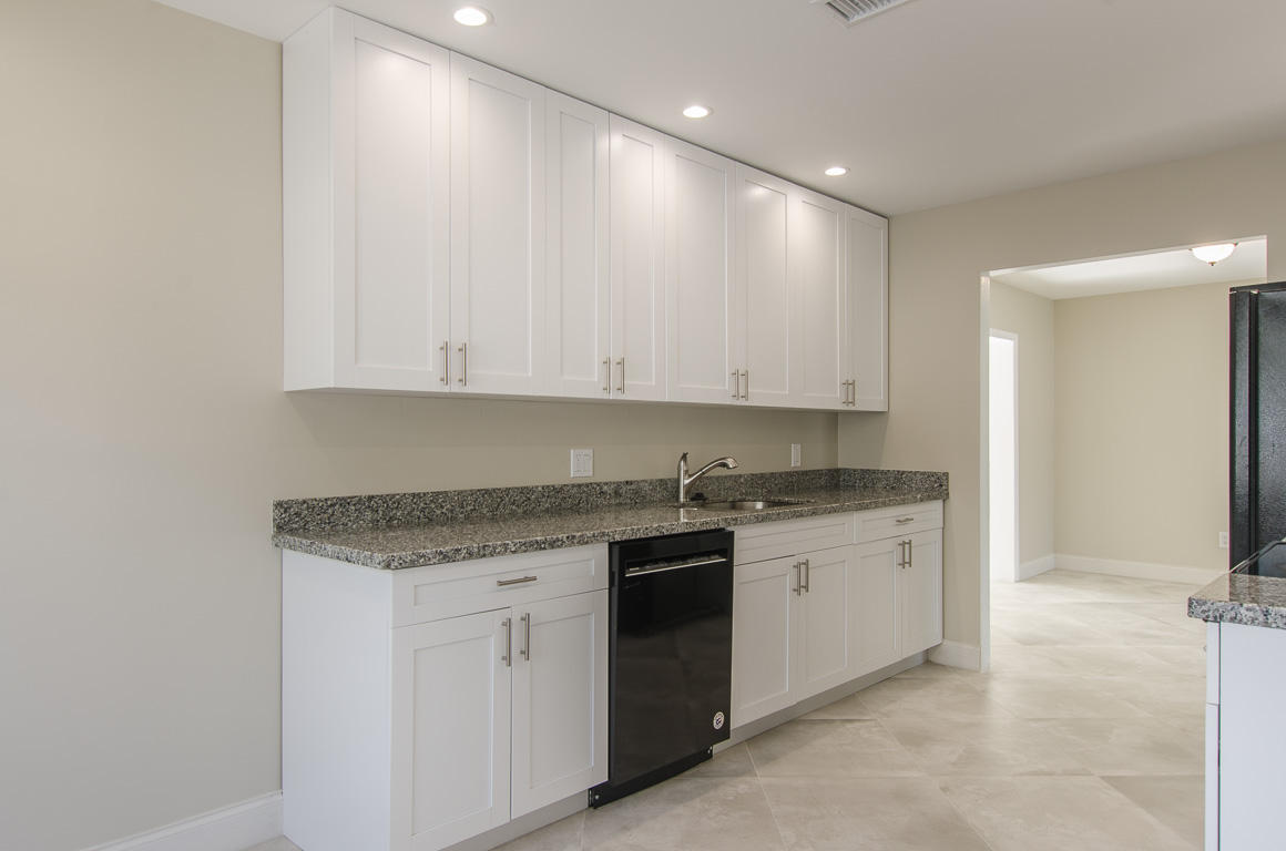 22710 Family Circle Boca Raton, FL 33428 - Photo 16 of 28 a view of a kitchen with a sink cabinets and wooden floor