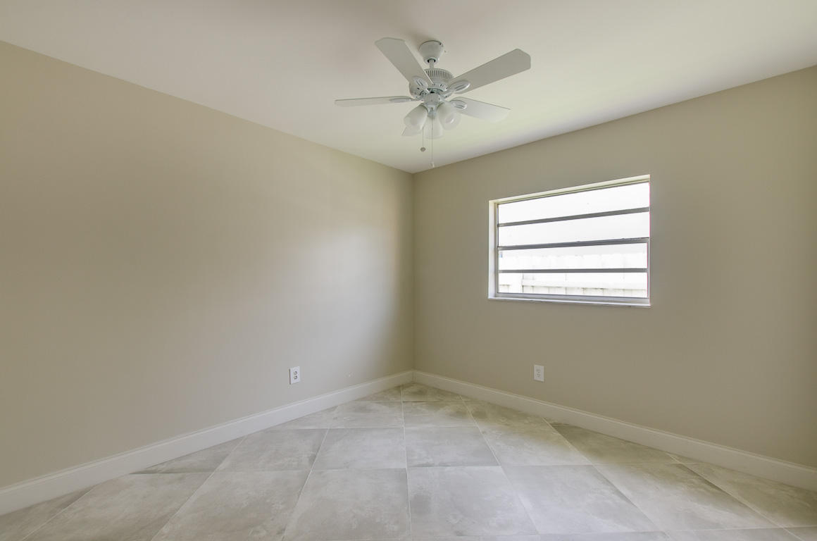 22710 Family Circle Boca Raton, FL 33428 - Photo 18 of 28 an empty room with a window and a fan