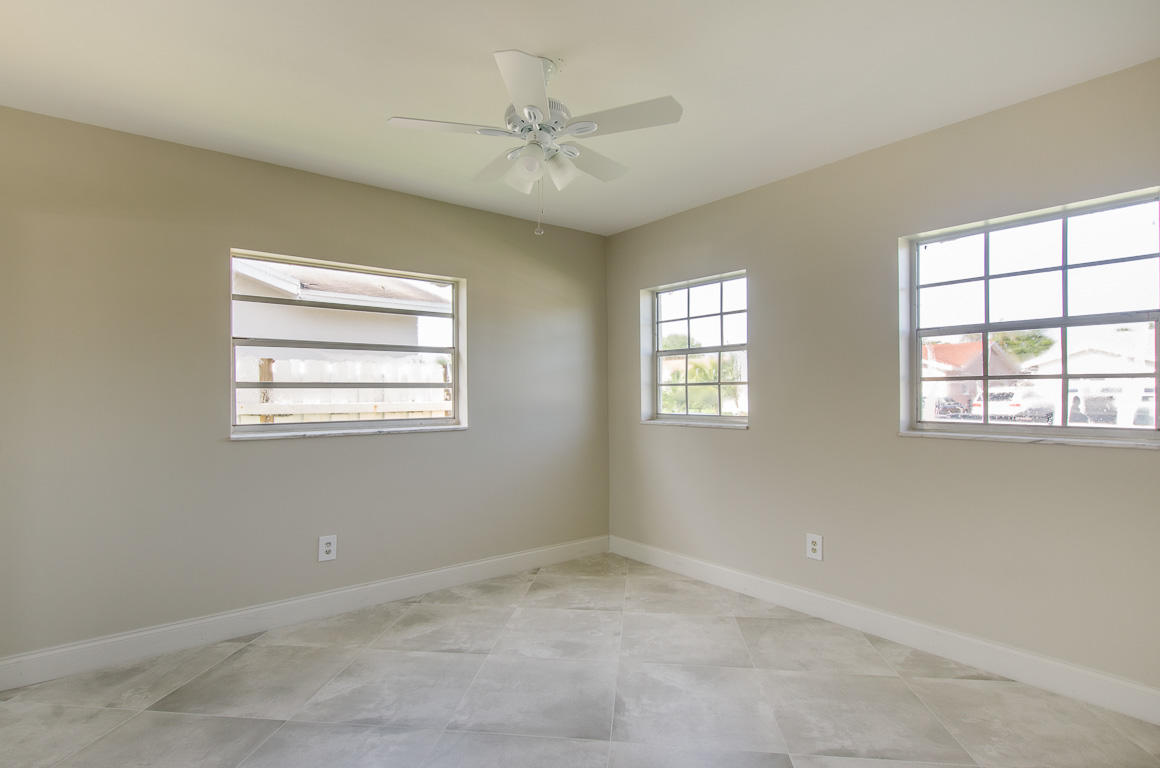 22710 Family Circle Boca Raton, FL 33428 - Photo 20 of 28 an empty room with windows and fan